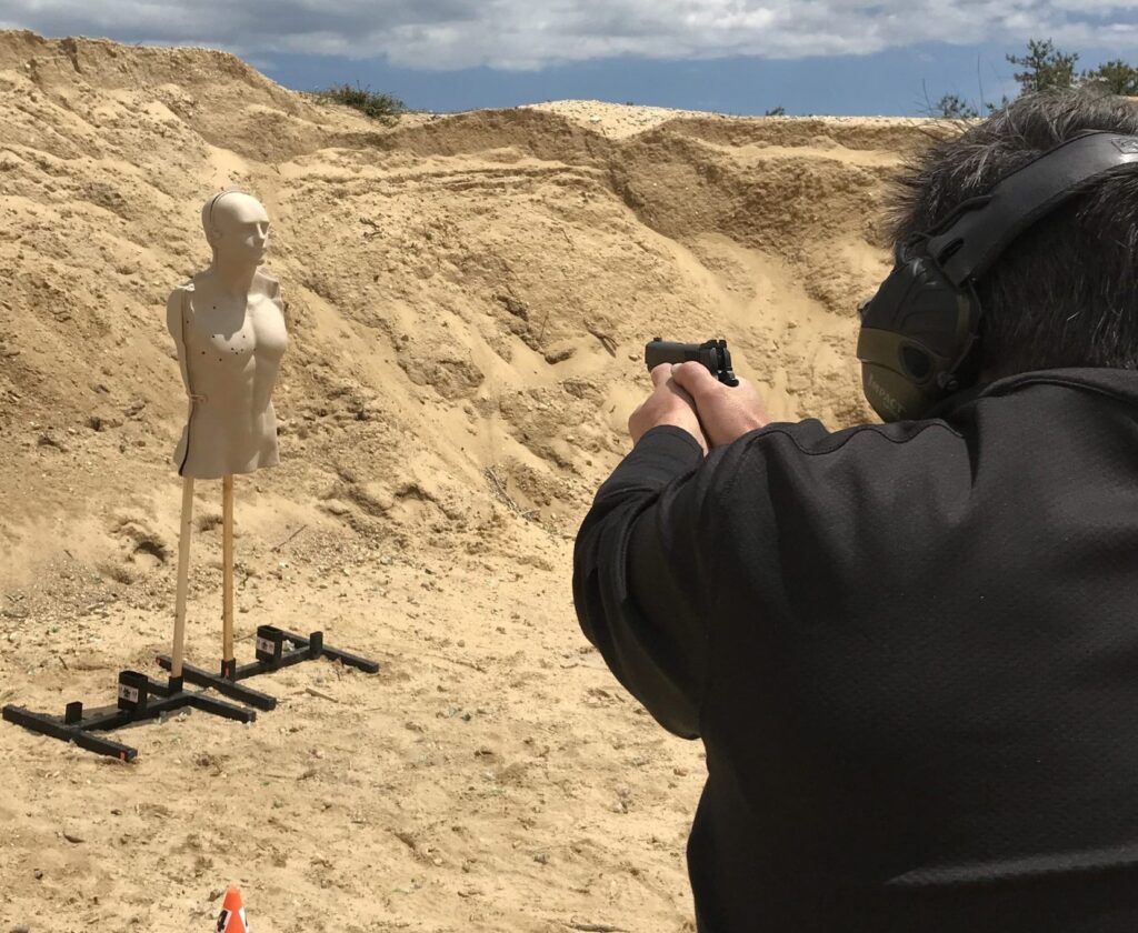 Student running a defensive pistol drill on the range