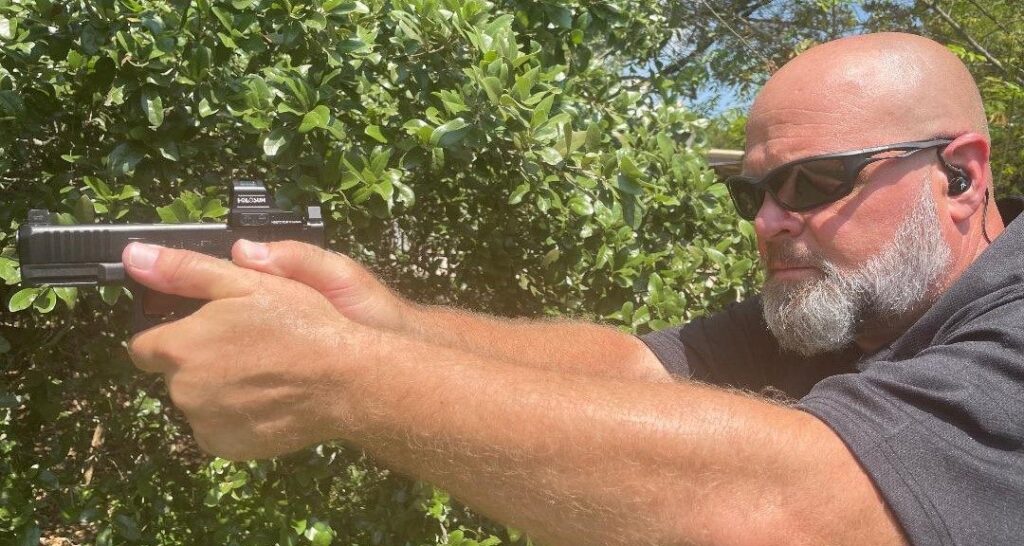 Frank Tooker, lead firearms instructor, demonstrating a proper two-handed pistol grip